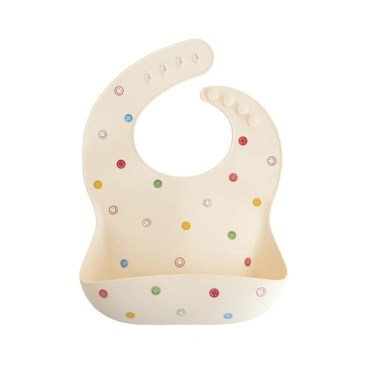 Mushie – Silicone Baby Bib in Smiley Face